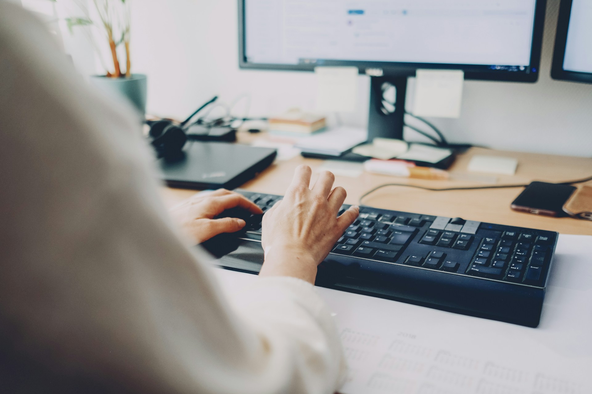 Korean work culture - a person typing on a keyboard in an office